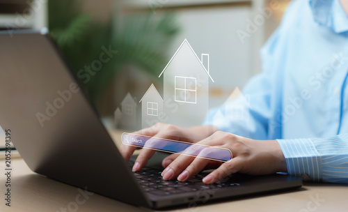 Obraz na płótnie Digital real estate search concept showing businesswoman using laptop to explore property listings, analyze market trends, and discover investment opportunities for property management