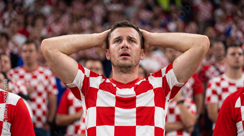 Stressed Croatian male soccer fan reacting to missed chance