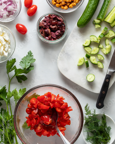 Ingredients and some process for making a greek salad.