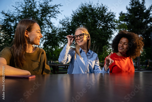 Young Women Exploring Augmented Reality Technology Outdoors