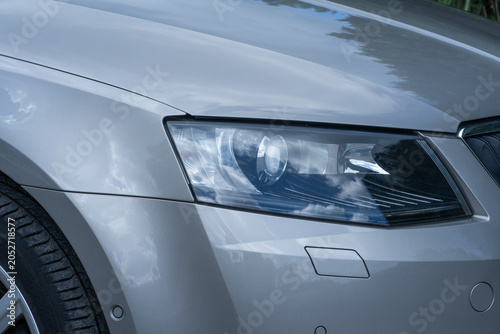 Valokuva Switched-off xenon headlights on a car showcase modern automotive lighting technology, even when not in use, emphasizing sleek design and advanced equipment