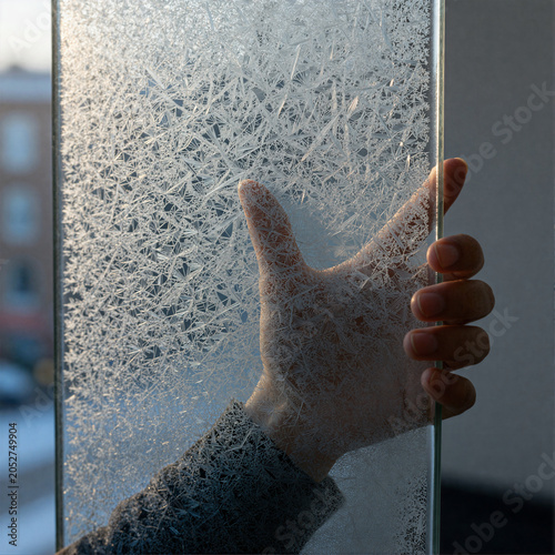 Frosted Glass with Hand in Winter Light