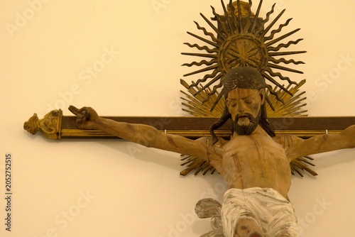 wood carving painted ornate statue of christ on a cross crucifixion