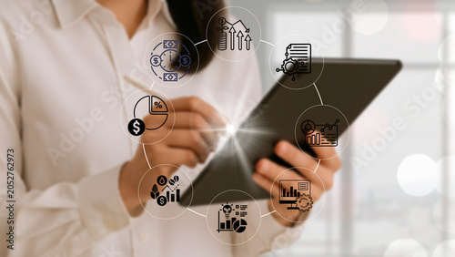 Tableau sur toile Business leaders analyze global business investment charts and graphs showing th
