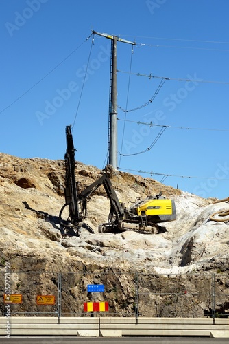 Drilling in progress with drilling machine in action in a quarry