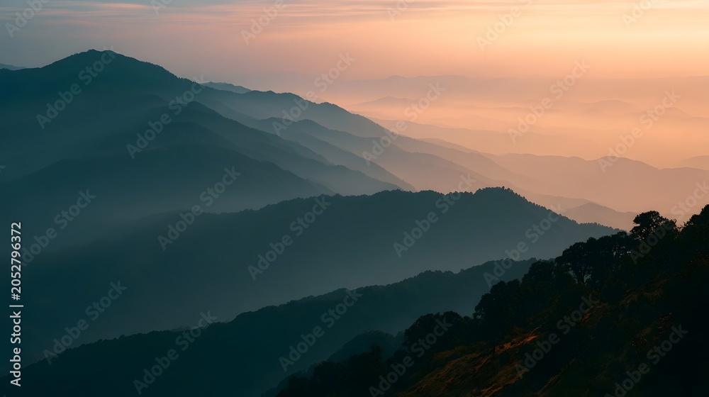 Obraz premium Misty mountains bathed in golden hour light create a breathtaking and serene landscape view