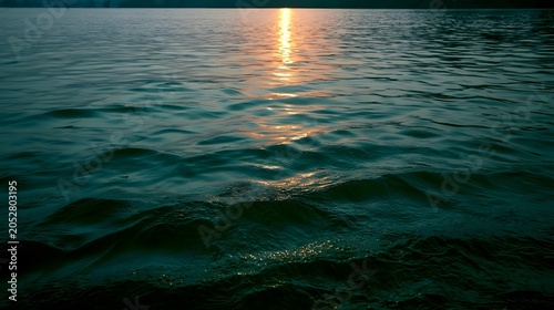 Majestic emerald green sea reflects the warm glow of the sunset creating a tranquil and exploratory mood