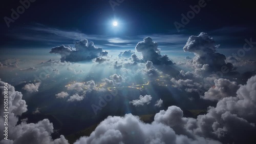 Flying above moonlit cloudscape panorama, beautiful night aerial cloud timelapse, bright full moon shines through moving animated cumulus clouds with peaceful light rays, night city lights.