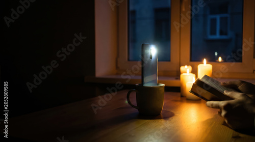 Smartphone Flashlight Illuminating Table During Home Power Outage