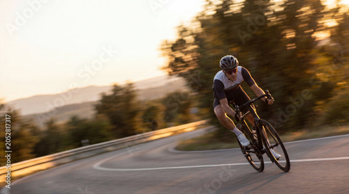 Road Cyclist Racing Along Scenic Coastal Highway at Sunset