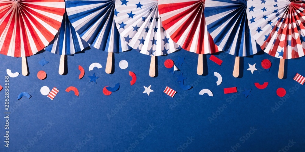Obraz premium Vibrant 4th of July Independence Day decorations, folded paper fans, scattered festive confetti