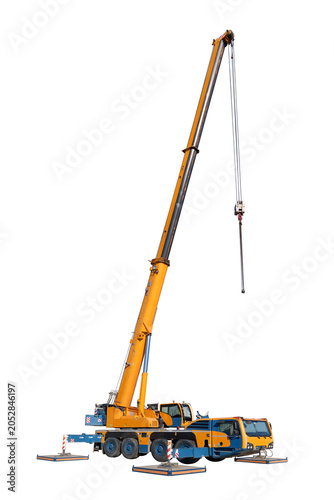Vertical view, isolated full-size image of a truck crane with its boom extended and hook hanging down, and with the stops on the sides of the machine extended, on a white background