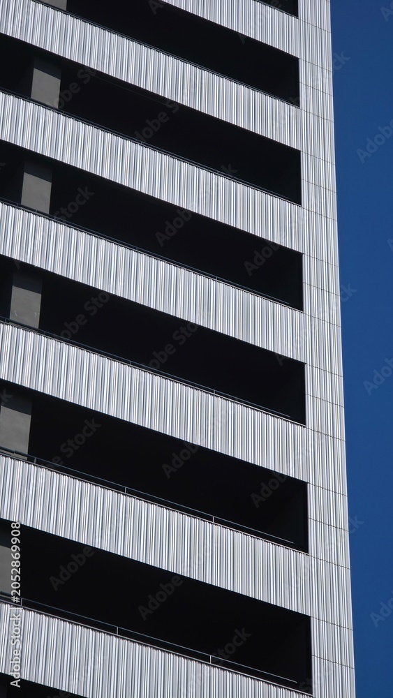 Fototapeta premium Modern building facade creating abstract striped pattern