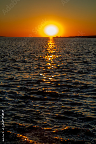 Sea at sunset - the waves reflecting the evening light