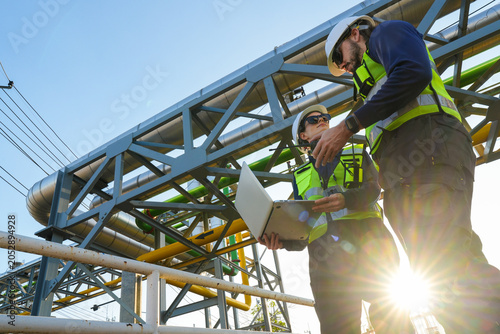 Konstfotografi Engineering project team conducting a critical site audit and schematic review of pipeline infrastructure to verify system specifications and operational compliance
