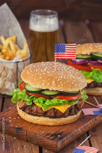 American Burger with bacon, cheese, tomato, lettuce and french fries at a Picnic for 4th of July