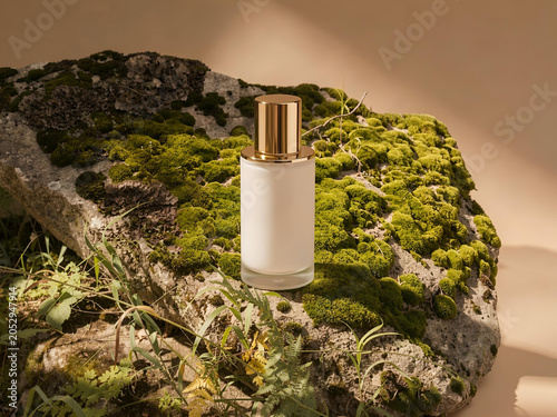 Mockup of a bottle of cosmetic cream placed on a natural stone with green moss. Organic skincare product advertising concept.