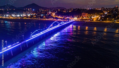 Illuminated Bridge over Calm Water at Night.