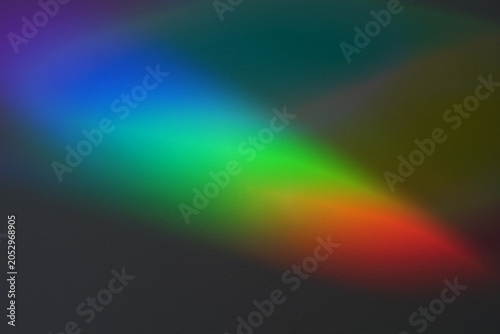 Soft focus rainbow neon noise grain blur texture prism reflection wall. Light and shadow smoke abstract gradient reflaction rays background.