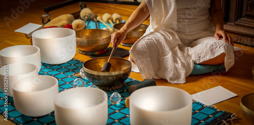 Obraz na plátne Stress Relief Sound Bath Meditation with Woman Playing White Quartz Crystal Sing