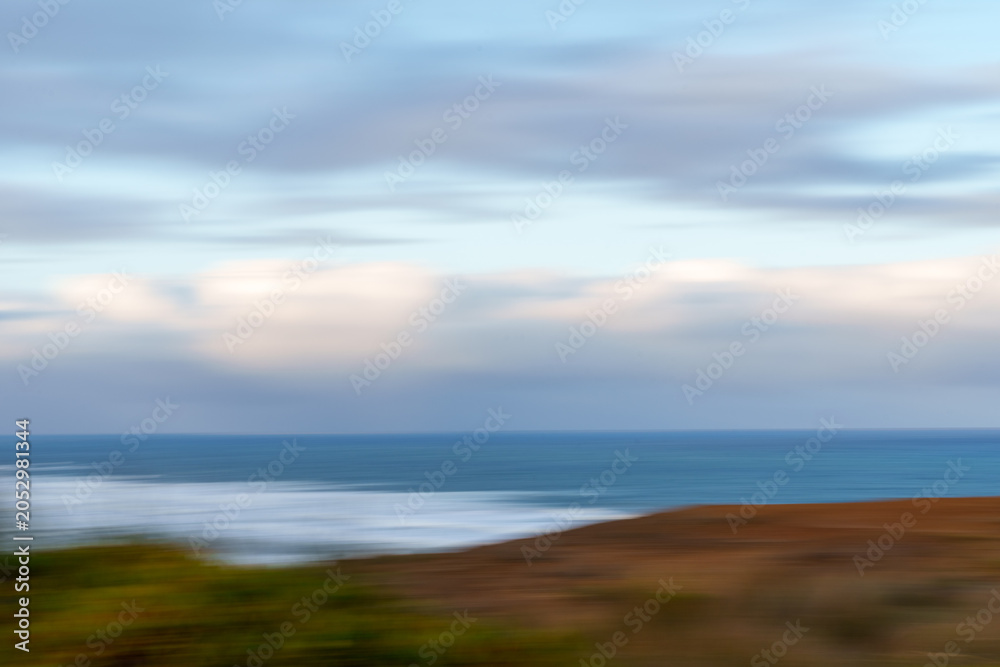 Obraz premium View from the coastal cliffs overlooking the Tasman Sea. It highlights west coasts famous rugged coastline, native New Zealand tussock and similar grasses in foreground