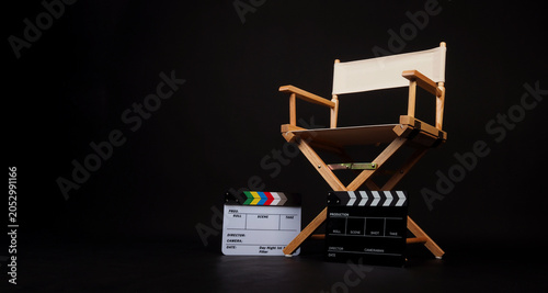 White director chair with two clapper board on black background.