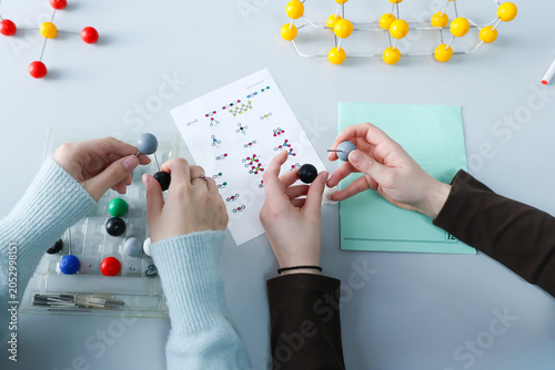 Students assemble molecular structure models while studying chemistry. Hands-on STEM education activity focused on molecular science, learning, teamwork and scientific understanding.High quality photo