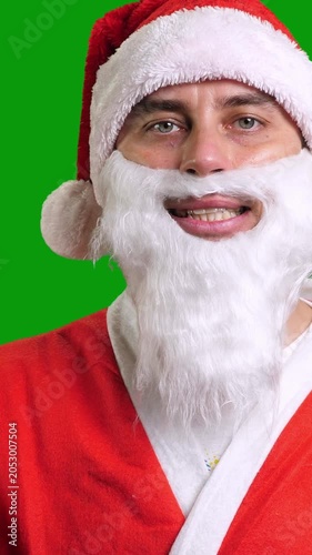 Santa Claus in red suit wag hand palm on green chroma key background. Christmas and New Year celebration concept. Vertical footage
