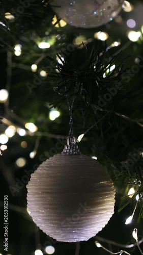 Christmas spruce tree decorated with balls and toys. New Year celebration. Closeup. Vertical footage