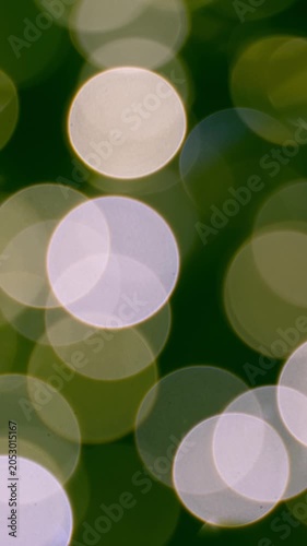 Abstract green background with defocused blinking lights. Vertical footage