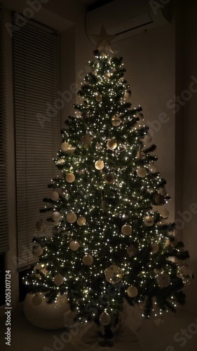 Christmas fir tree decorated with lights, balls and toys. New Year celebration. Closeup. Vertical footage