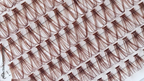 False eyelashes extension set with brown lashes, closeup. Makeup accessories. Rotating