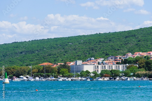 Boats on the Blue Sea with View of Krk and Forested Hills