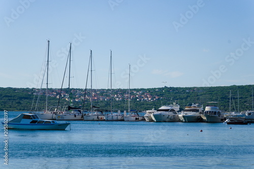 Boats and Yachts on the Blue Sea with View of Krk at Sunset