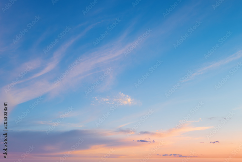 Fototapeta premium Beautiful sunset sky background with soft clouds. Pastel sunrise sky texture representing freedom, inspiration and serenity.