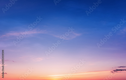 Vivid dusk sky background at sunset with calm atmosphere. Beautiful twilight sky background visualizing peace, harmony and tranquility.
