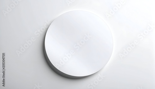 A clean, white, circular object rests on a light-colored surface, shadowed