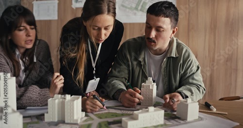 Team discussing an architectural model in an office