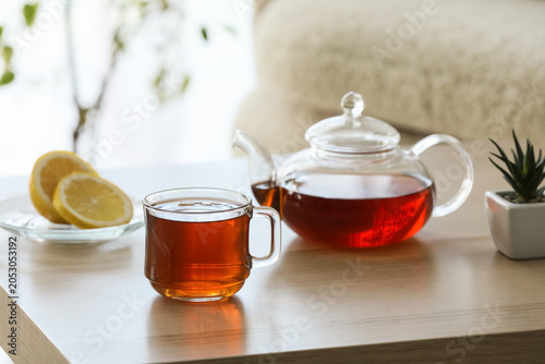 Glass cup and teapot of hot...