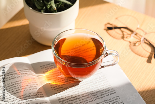 Book and cup of black tea o...
