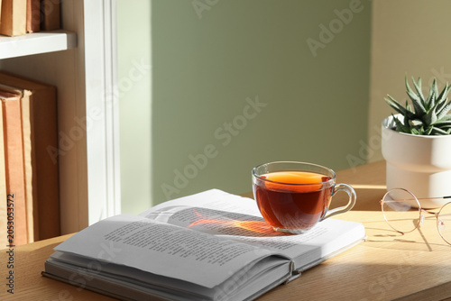 Book and cup of black tea o...
