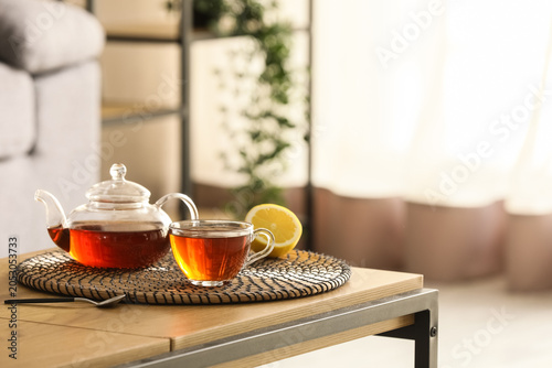 Cup of hot black tea, teapo...