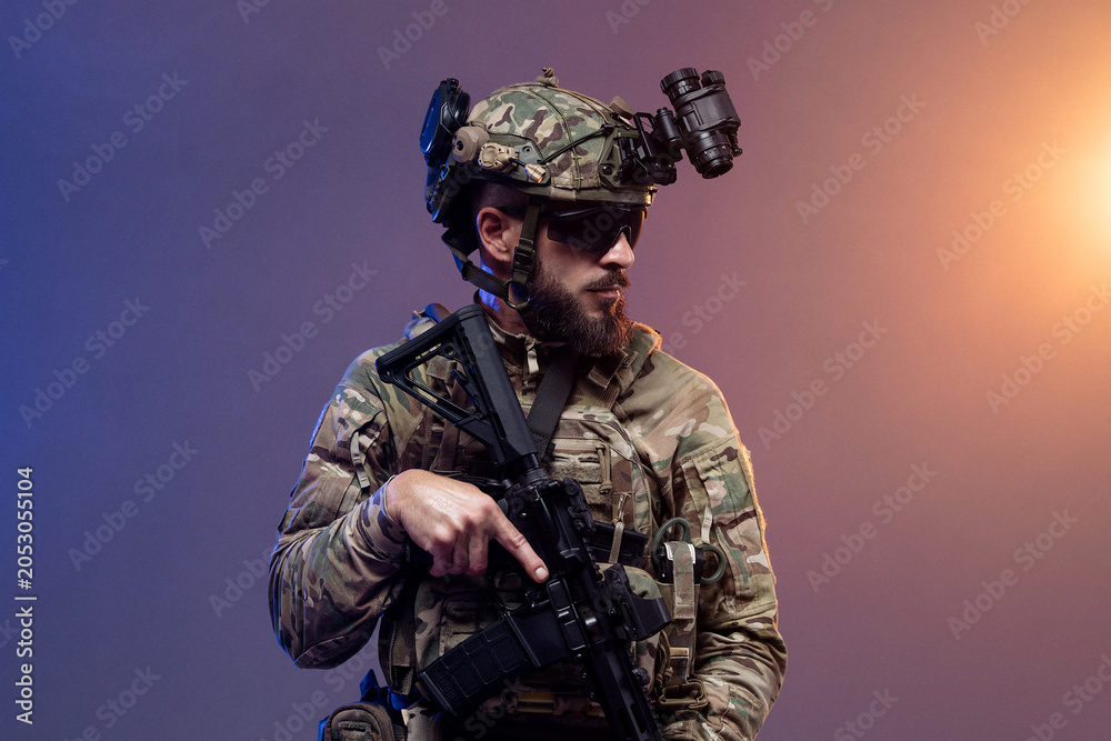 Fototapeta premium Military professional in camouflage uniform with rifle and night vision device on isolated background. Concept armed forces and tactical operations. 