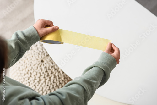 Young woman with masking ta...
