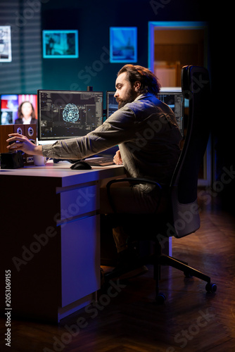 Photos Developer inserting disk into PC containing language data models able to create conscious AI, with IT admin placing cartridge in computer with machine learning data awakening artificial intelligence