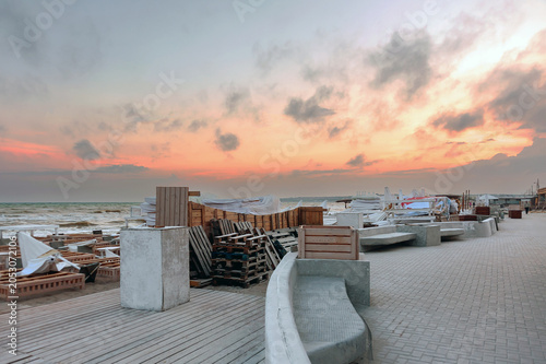 A quiet, evening on the promenade of Kobleve, Ukraine with beach infrastructure dismantled and stored away