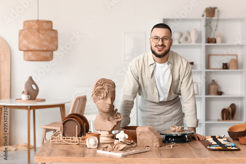 Young male sculptor with cl...