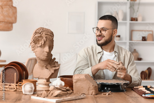 Young male sculptor with bu...