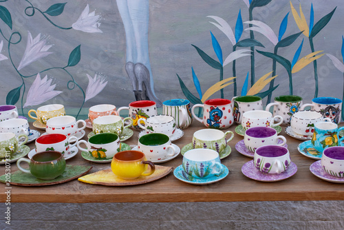 Handcrafted Ceramic Cups and Mugs Displayed on Rustic Wooden Table