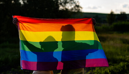 couple holding rainbow flag for pride month